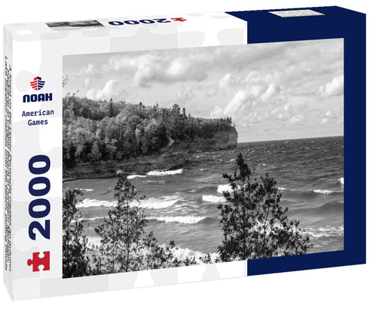 Noah Jigsaw Puzzle A forest on the Upper Peninsula creates an autumn backdrop at Chapel Beach in northern Michigan. Lake Superior crashes onto the beach, puffing clouds of white across the blue sky in black white 2000 pieces