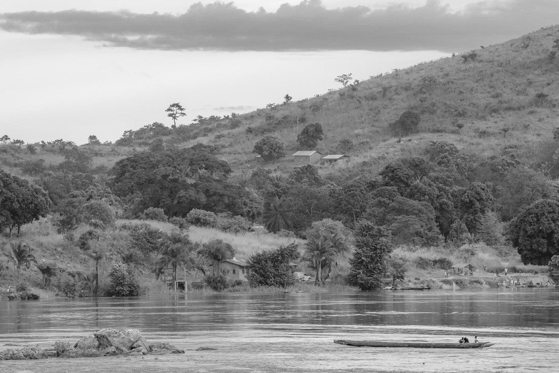Noah Jigsaw Puzzle African fisherman rowing boat on Ubangi River, fishing in Bangui capital of Central African Republic. Traditional wooden boat made by African villagers in black white 2000 pieces