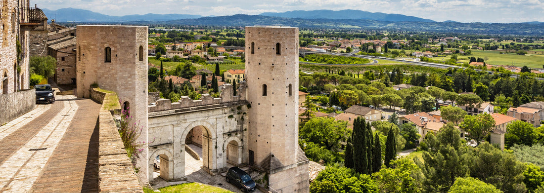 The Porta di Venere from the Roman period, made of white travertine, with its three arches and the two towers of Properzio. In Spello, province of Perugia, Umbria, Italy 1000pc Panoramic Puzzle
