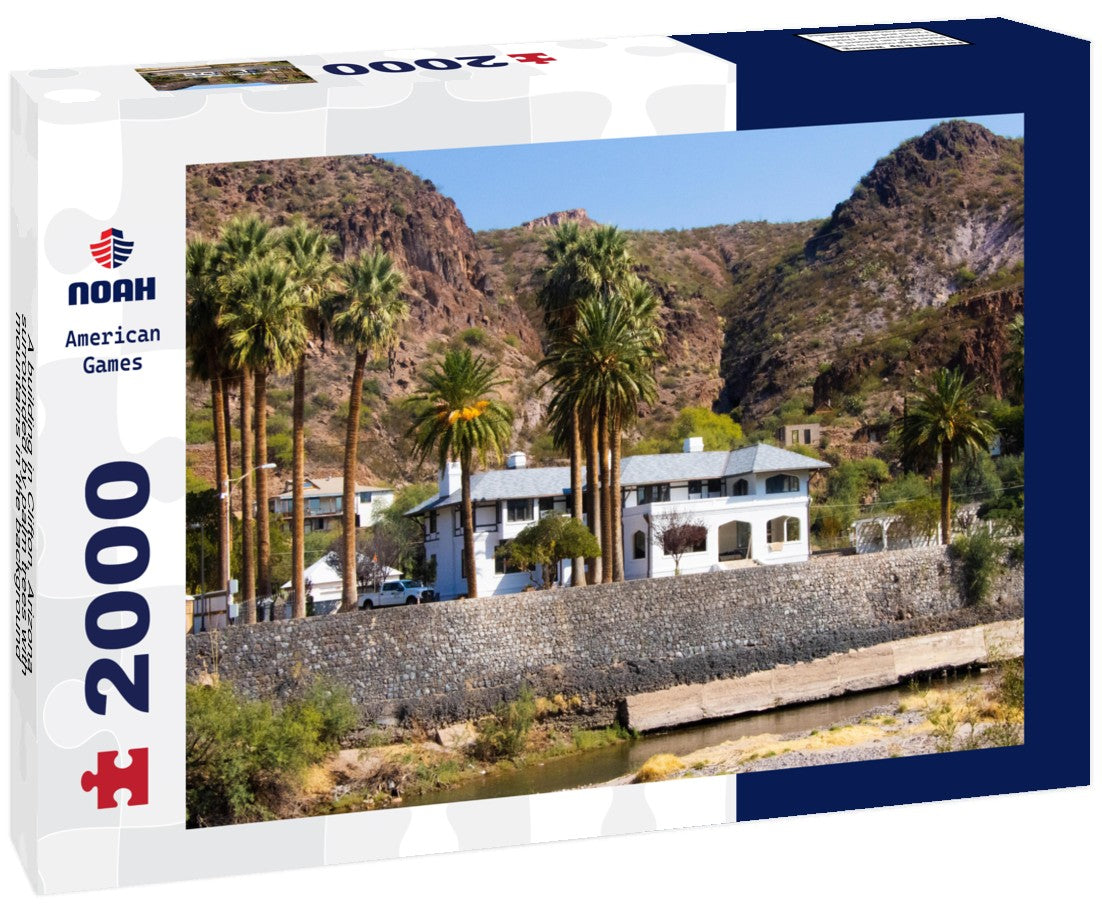 A building in Clifton, Arizona, surrounded by palm trees with mountains in the background, in Greenlee County, USA 2000pc Puzzle