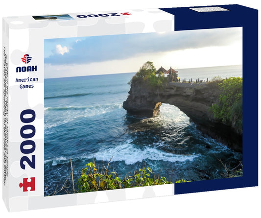 Noah Jigsaw Puzzle Cliffs in the nearby of Tanah Lot Temple, Bali, Indonesia. There is an arch in the water. The waves are splashing on the cliffs and smaller rocks. Water stays on the flat surfaces. Power of the nature 2000 pieces