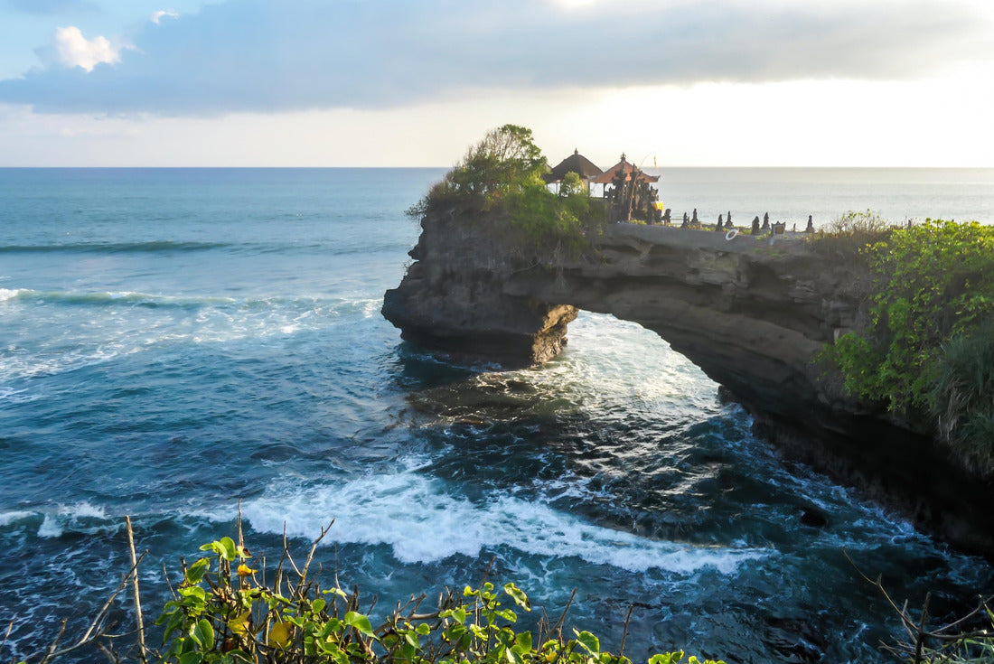 Cliffs in the nearby of Tanah Lot Temple, Bali, Indonesia. There is an arch in the water. The waves are splashing on the cliffs and smaller rocks. Water stays on the flat surfaces. Power of the nature 2000pc Puzzle