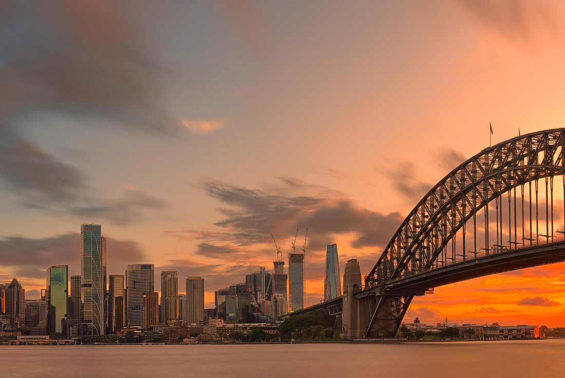 Sydney Harbour Bridge, Opera House and skyscrapers in the city are shrouded in pink afterglow under the reflection of the setting sun 2000pc Puzzle