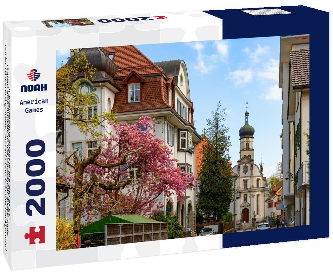 A picturesque street in the city of St. Gallen with houses in the traditional Swiss style under blossoming trees, an old church in the background 2000pc Puzzle
