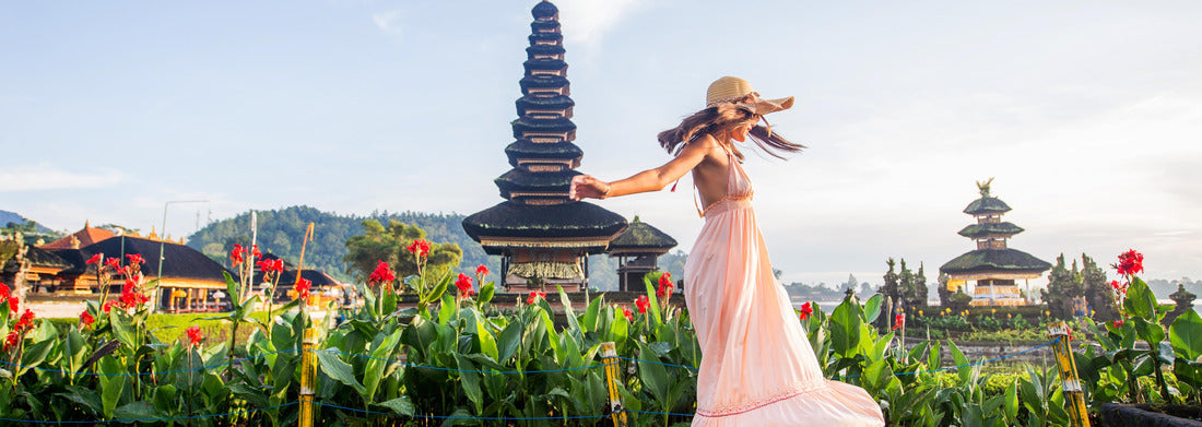 Noah Jigsaw Puzzle Young woman at the Pura Ulun Danu Bratan, Bali. Hindu temple surrounded by flowers on Bratan lake, Bali panorama 1000 pieces