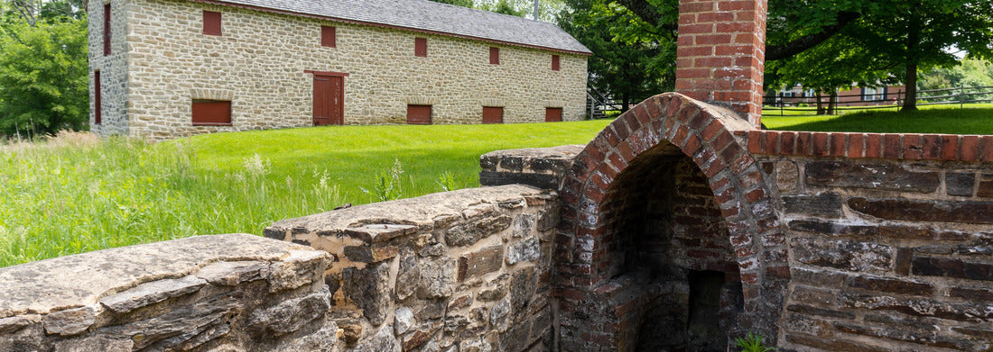 Towson, Maryland: Hampton National Historic Site. Long House granary and outdoor fireplace. The two-story stone structure served as a rooster hut and granary during historic times. 1000pc Panoramic Puzzle