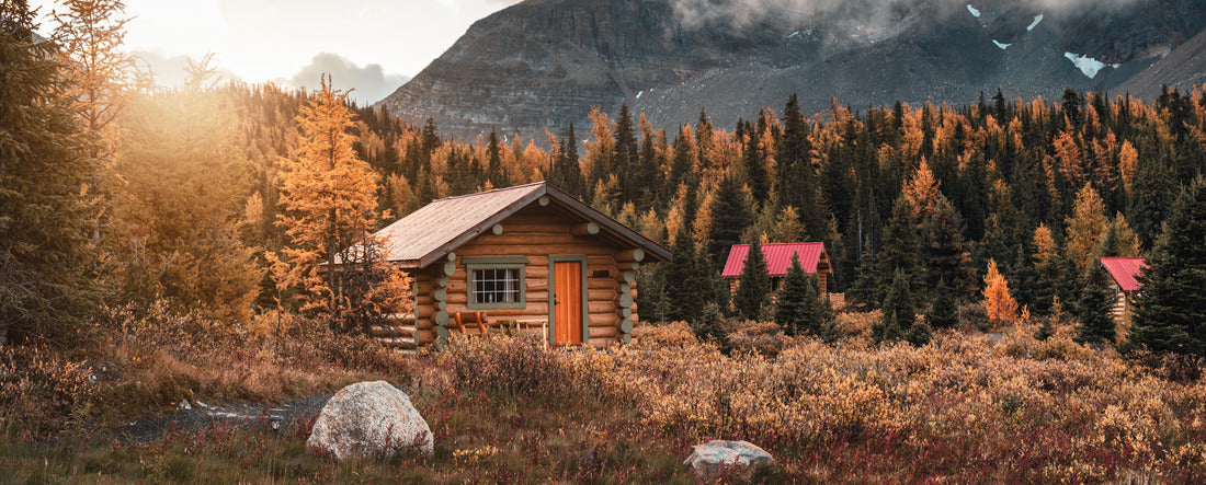 Cabins bathed in sunshine in fall forest in Assiniboine Provincial Park, Canada 2000pc Panoramic Puzzle