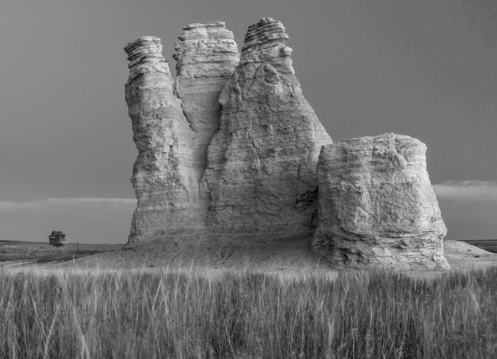Castle Rock - limestone pillar landmark in prairie of western Kansas near Quinter (Gove County), windy fall morning before sunrise in black white