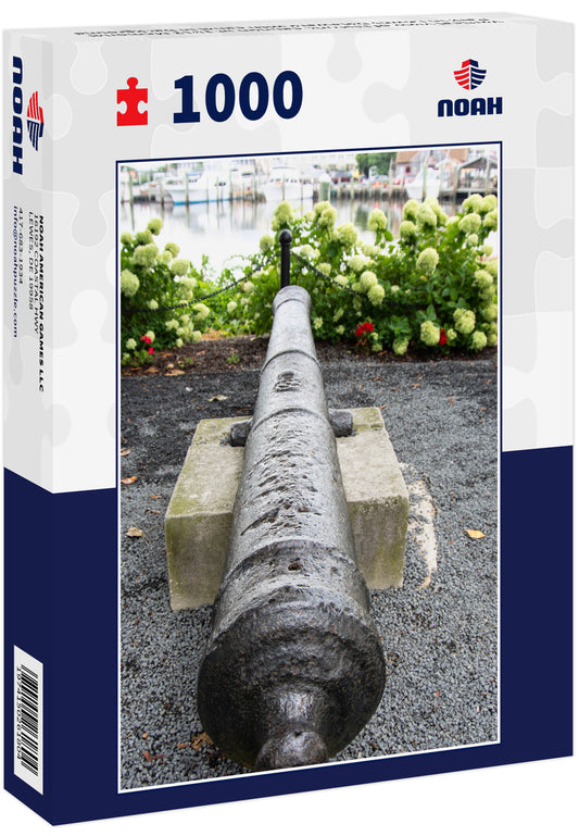 Vertical view of historic cannon at 1812 Memorial Park in Lewes Delaware with canal in background