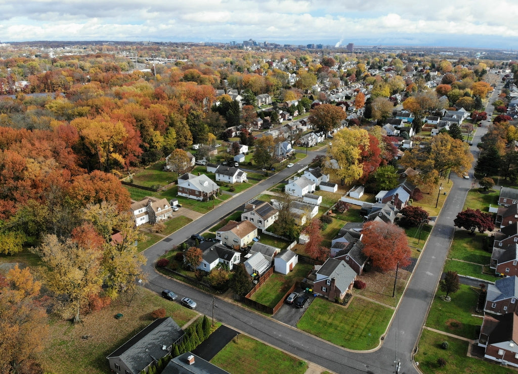 The aerial view of the residential neighborhood surrounded by stunning colors of fall foliage near Newport, Delaware, U.S.A