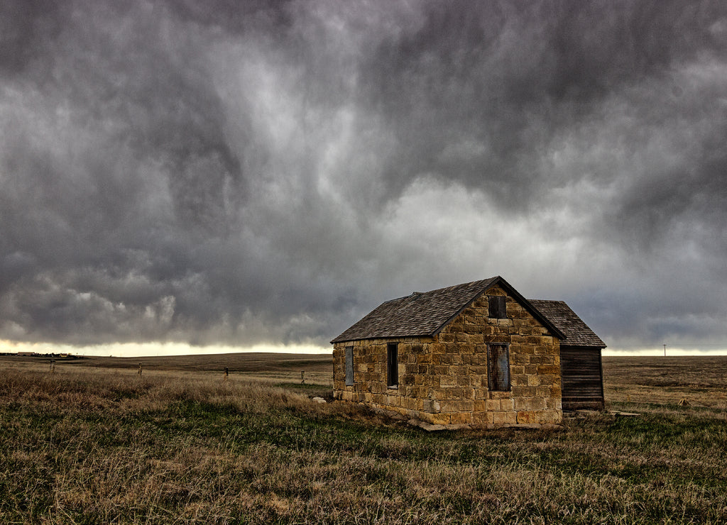 Ellis County, Kansas USA - Abandoned Limestone Farmhouse in the Midwest Prairie under Thunderstorm Skies