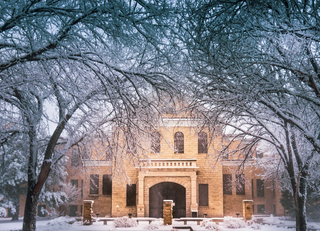 Hays, Kansas USA - Fort Hays State University's Picken Hall Front Peeking through Snow Covered Tree Branches