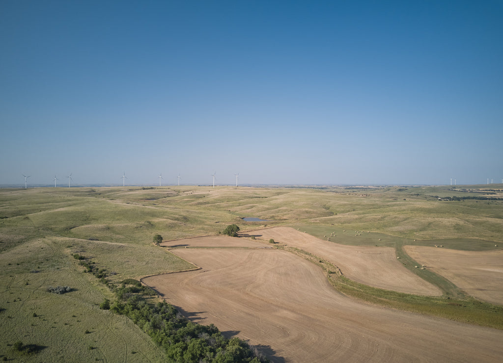 Aerial drone image of Farmland and wind turbines in the state of Kansas