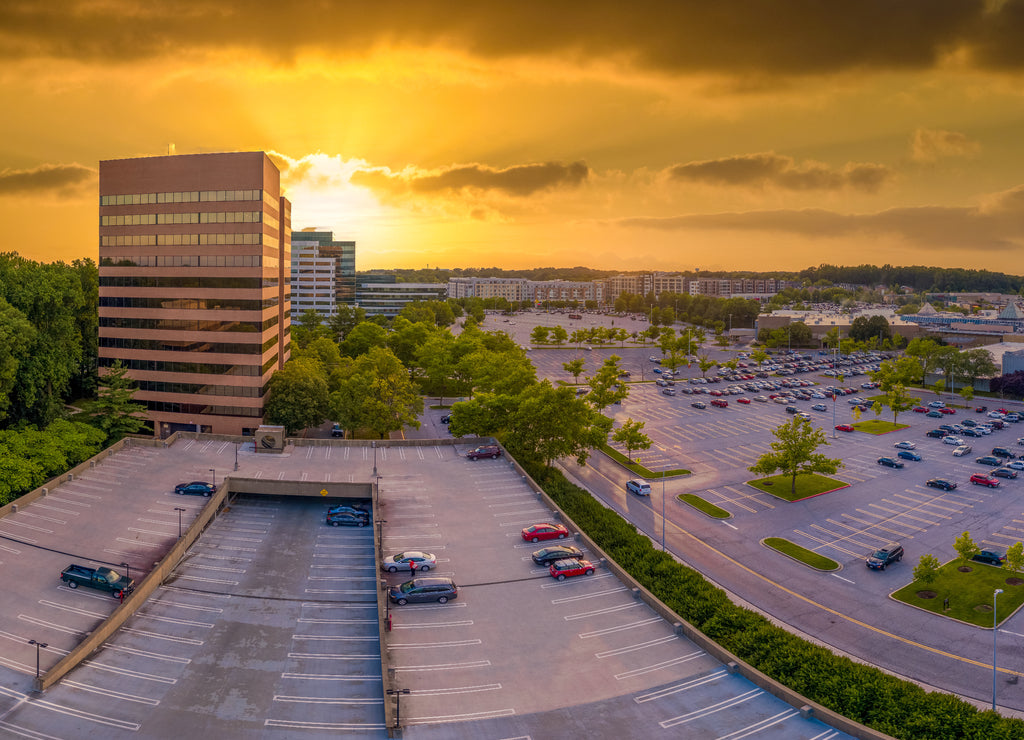 Yellow, orange sunset sky behind the commercial office buildings at Columbia Town Center Howard County Maryland United States