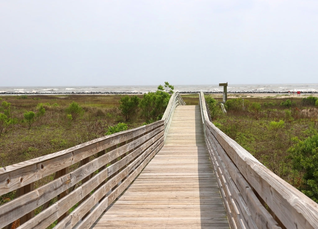 Louisiana wildlife and nature background. Way to the deserted beach area along wooden boardwalk over the sand dunes at the Grand Isle State Park, Louisiana, South USA