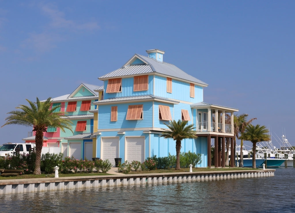Travel America and visit Louisiana background. Neighborhood, rebuilt after a hurricane, with brightly colored houses for vacation rentals near Grand Isle State Park, Louisiana, USA