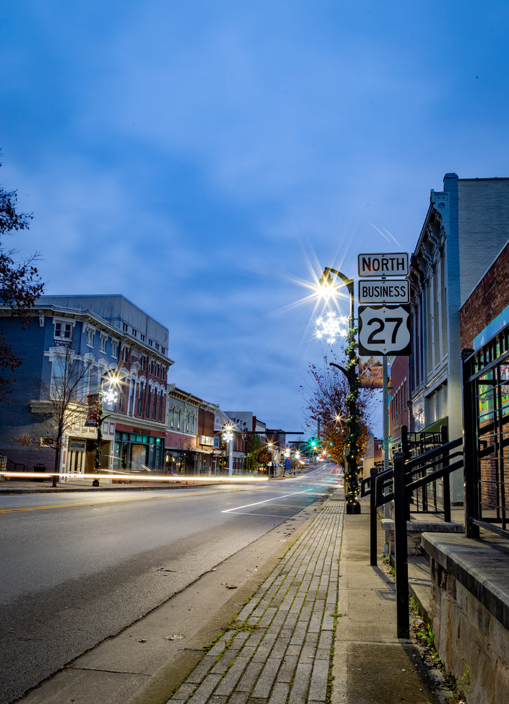 Early morning view of main street Nicholasville, Kentucky with Christmas decorations on lamp posts and sign of road 27 on the foreground