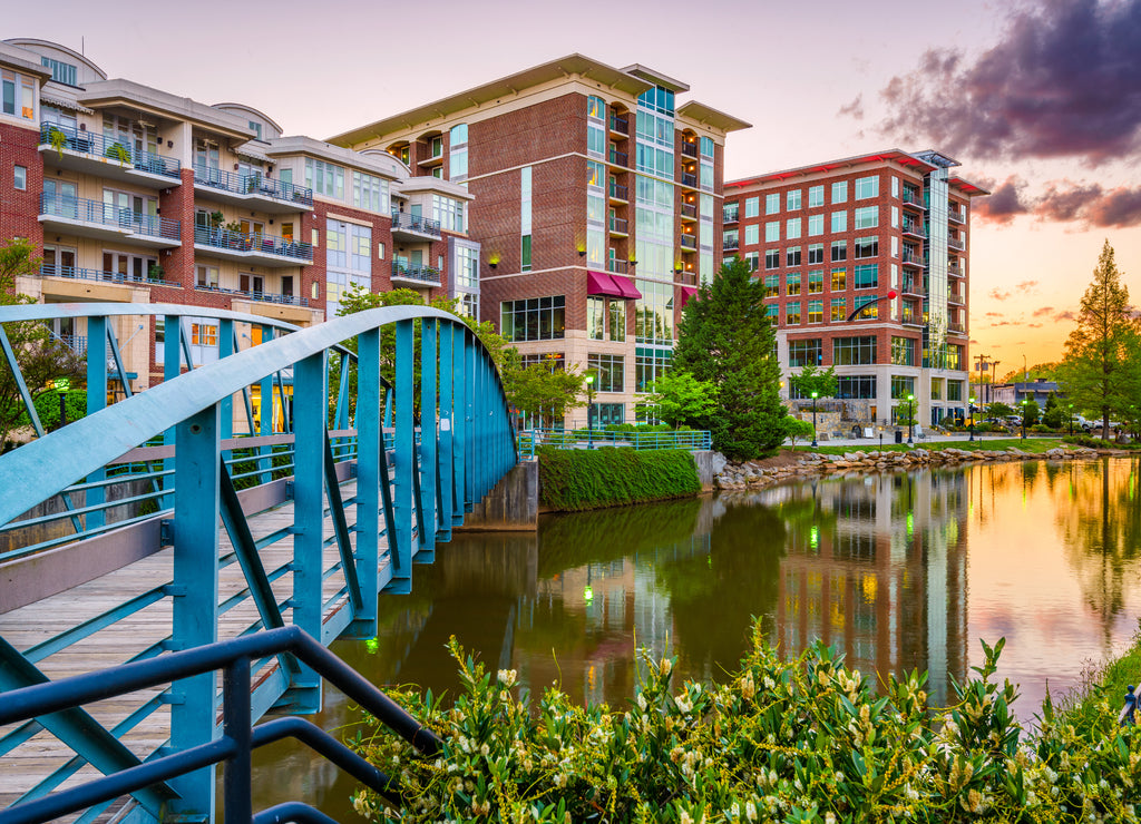Greenville, South Carolina, USA downtown cityscape on the Reedy River at dusk
