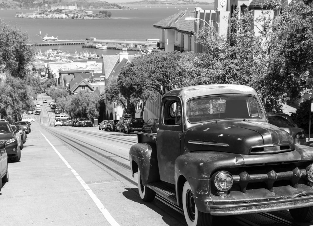 San Francisco Hyde Street and vintage car with Alcatraz, California in black white