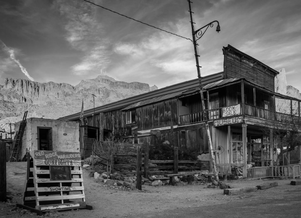 Evening light on a building and mountains in Oatman, Arizona in black white