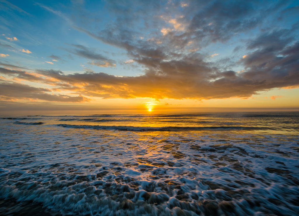 Waves in the Atlantic Ocean and sunrise, in Isle of Palms, South Carolina