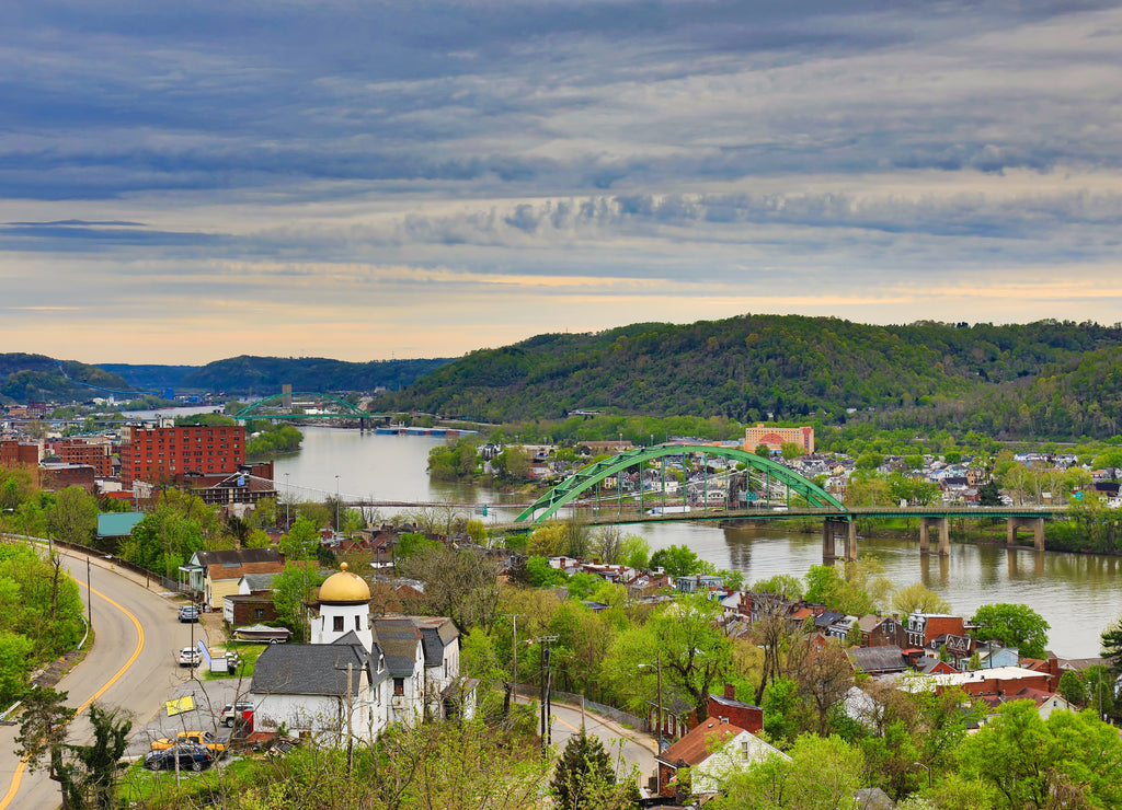 This is an aerial view of Wheeling, West Virginia along the Ohio River. This skyline cityscape shows Wheeling Island in the distance