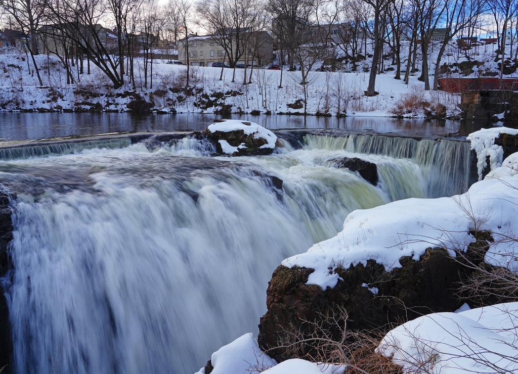 Winter view of the Great Falls of the Passaic River, part of the Paterson Great Falls National Historical Park in New Jersey, United States, after a snow storm