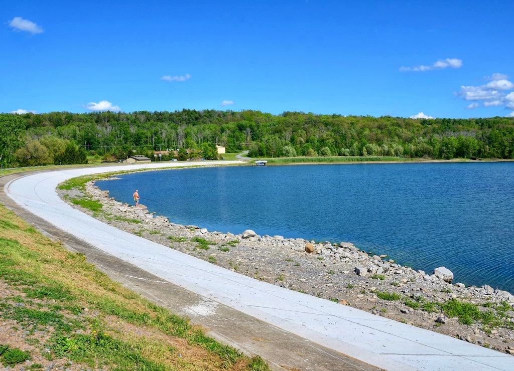 Hemlock Lake with curved dam, one of the minor Finger Lakes. It is mostly located in Livingston County, New York, south of Rochester. It’s forever-wild, tranquil landscape the perfect place to unwind