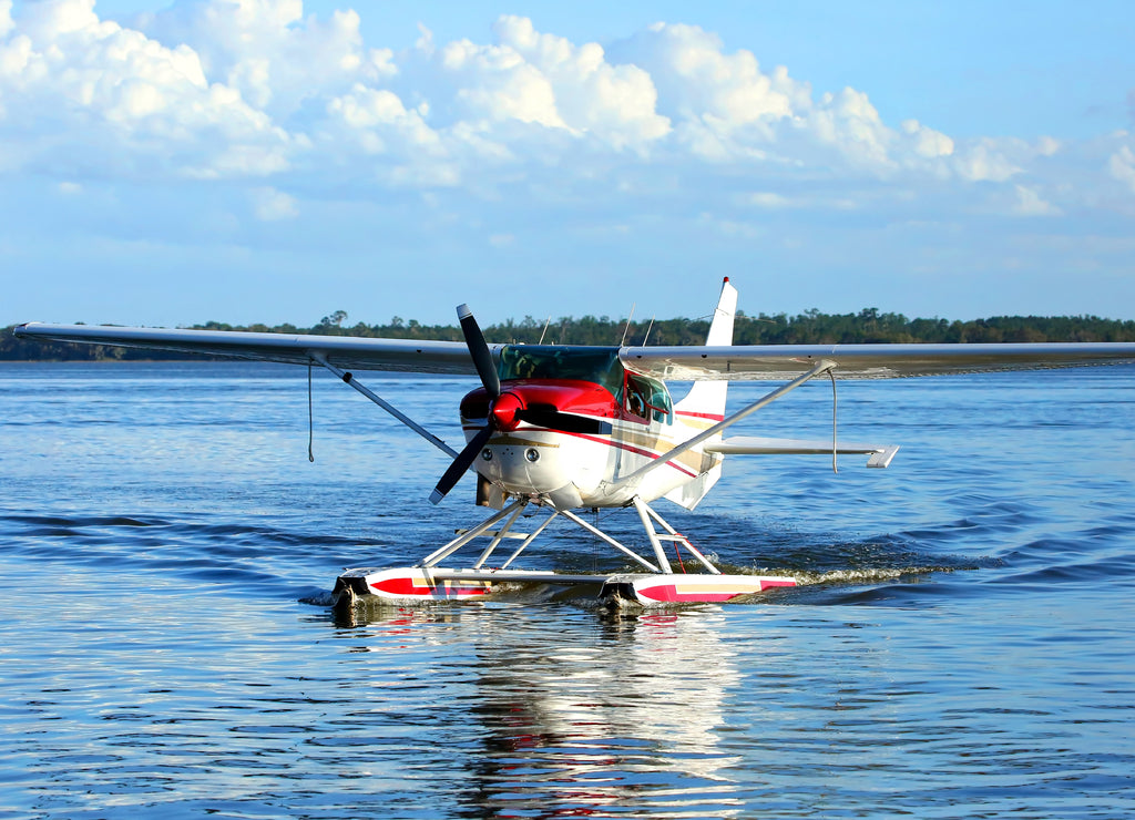 Single engine seaplane turns in the water and prepares to stop at Wooten Park, Tavares, Florida, USA