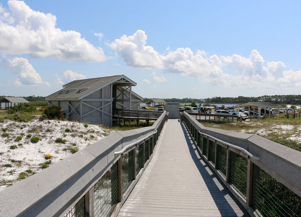 beach boardwalk over sand dunes with blue sky background at santa rosa florida state park
