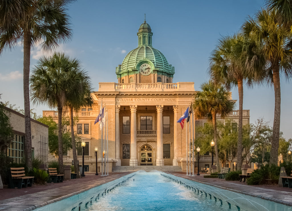 Historic Volusia County Courthouse with copper dome from fountain pool in DeLand, Florida