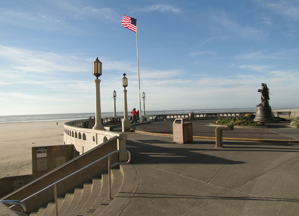 American flag and lamp posts on beach promenade Seaside, Oregon coast