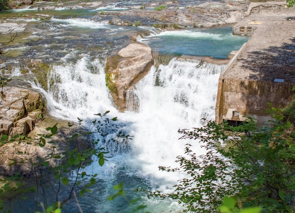 Majestic Steamboat Falls and the Fish Ladders of the North Umpqua National Forest gushing from a blue drainage in the mountains of Douglas County southern Oregon in the springtime