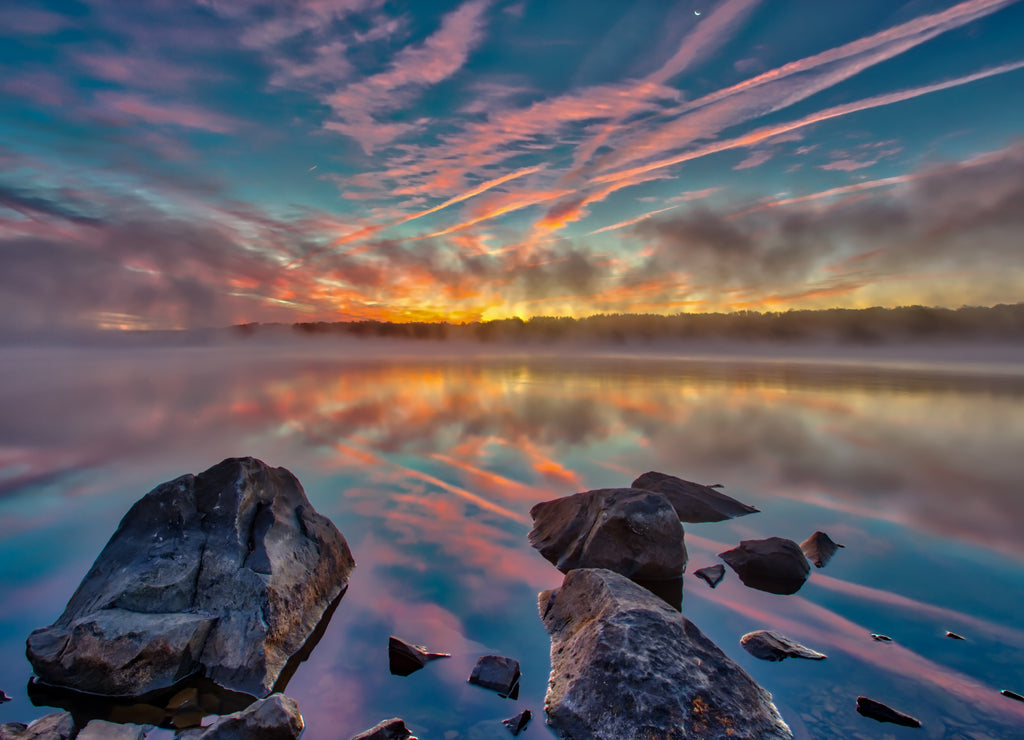 Foggy pre-sunrise skies over the lake in Nockamixon State Park located in Bucks County Pennsylvania