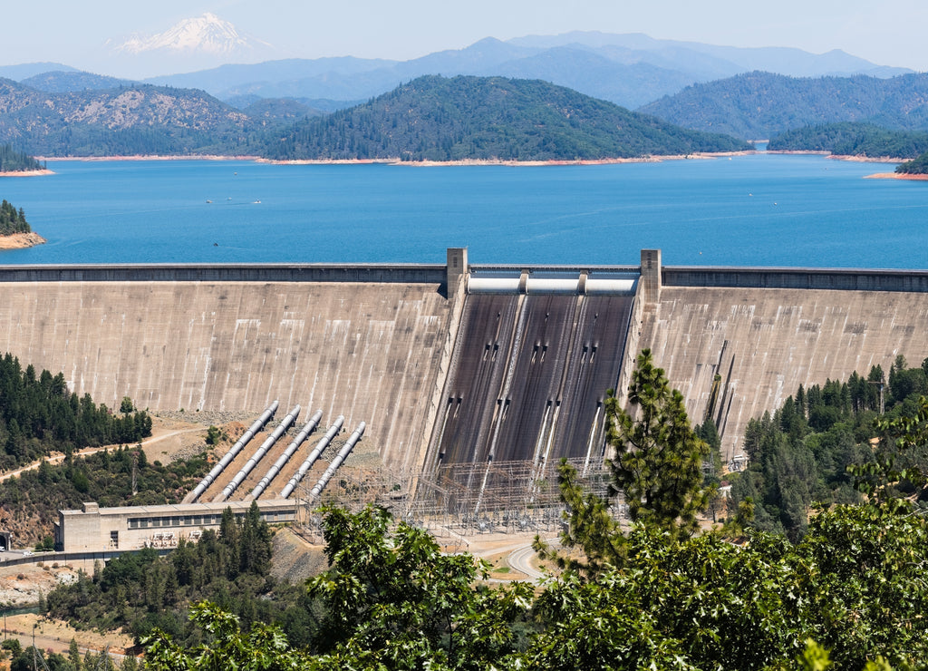 Panoramic view of Shasta Dam on a sunny day, Shasta mountain visible in the background; Northern California