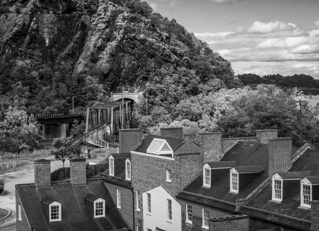 View of historic buildings and a railroad tunnel in Harpers Ferry, West Virginia in black white