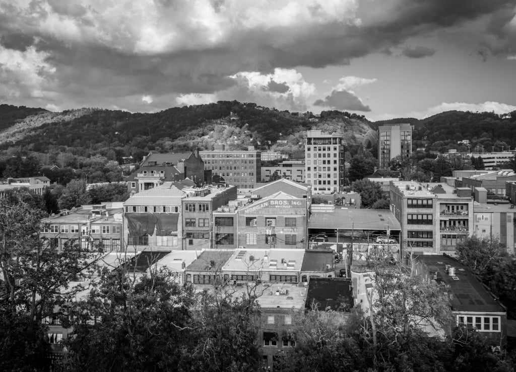 View of mountains and buildings in downtown Asheville, North Carolina in black white