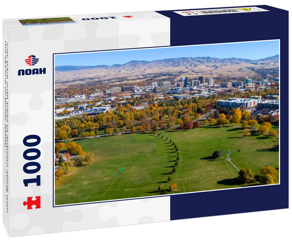 City park with trees in autumn along with the skyline of Boise, Idaho