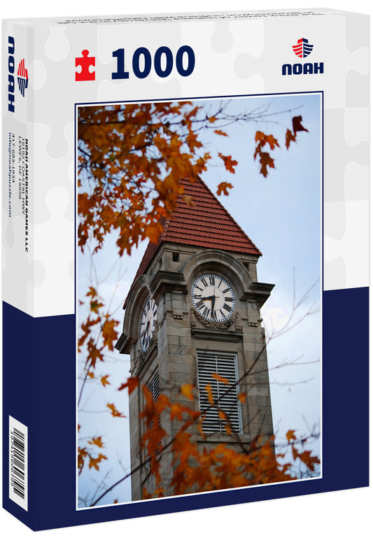 The clock tower of Indiana University in the fall in Bloomington, Indiana with colorful leaves