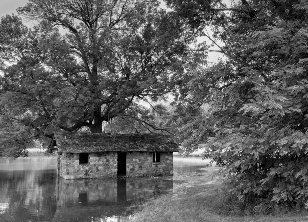 Flooded tornado shelter near Des Moines River, Boone county, Iowa, USA in black white