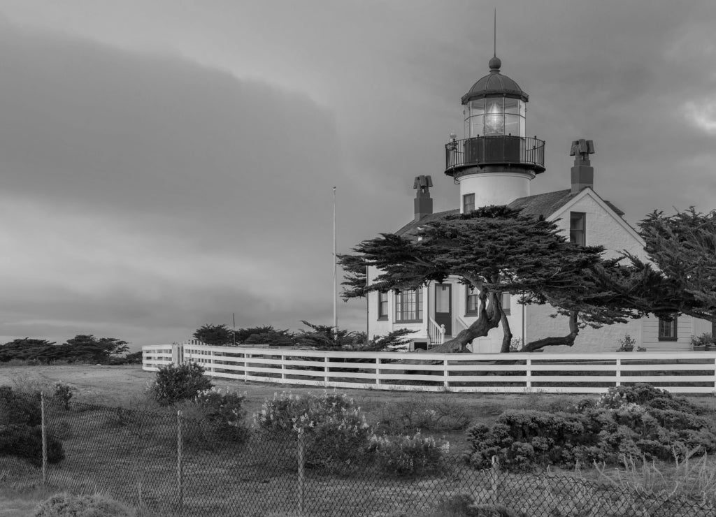 California lighthouse with dramatic sky. Point Pinos lighthouse at sunset in Pacific Grove, Monterey, California in black white