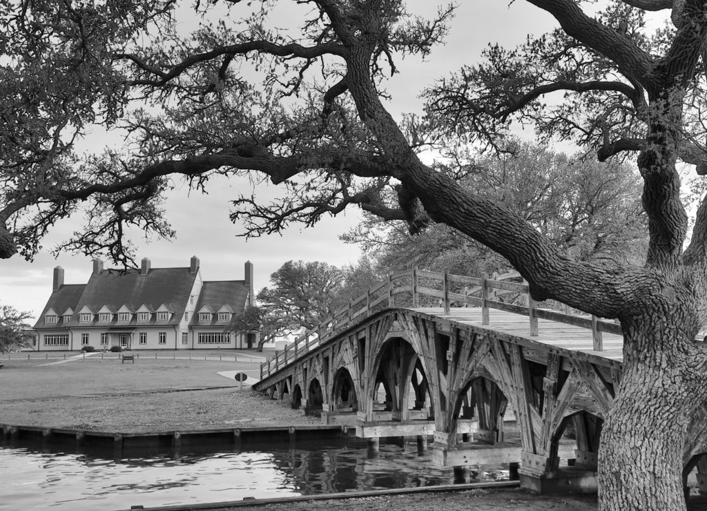 The historic landmark footbridge in Currituck Heritage Park leads to the Whalehead Club. This is located in the Outer Banks of North Carolina in black white
