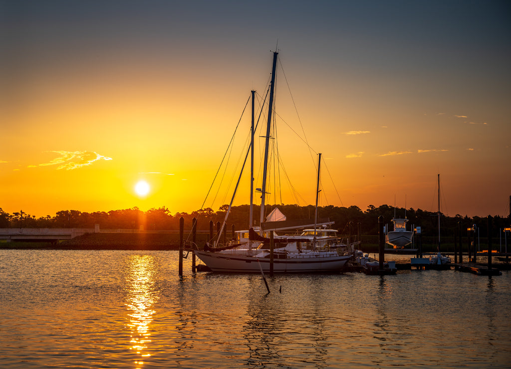 Sailboats at Sunrise at the marina on calm water in Beaufort North Carolina