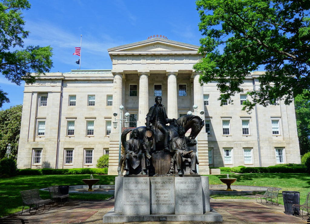 The North Carolina State Capitol building in Raleigh North Carolina with the statue of the three US Presidents born in North Carolina